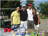 Golfers Beside a Snack Table Containing Granola Bars and Cinnamon Rolls