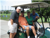 Four Golfers Take a Picture in Their Golf Cart