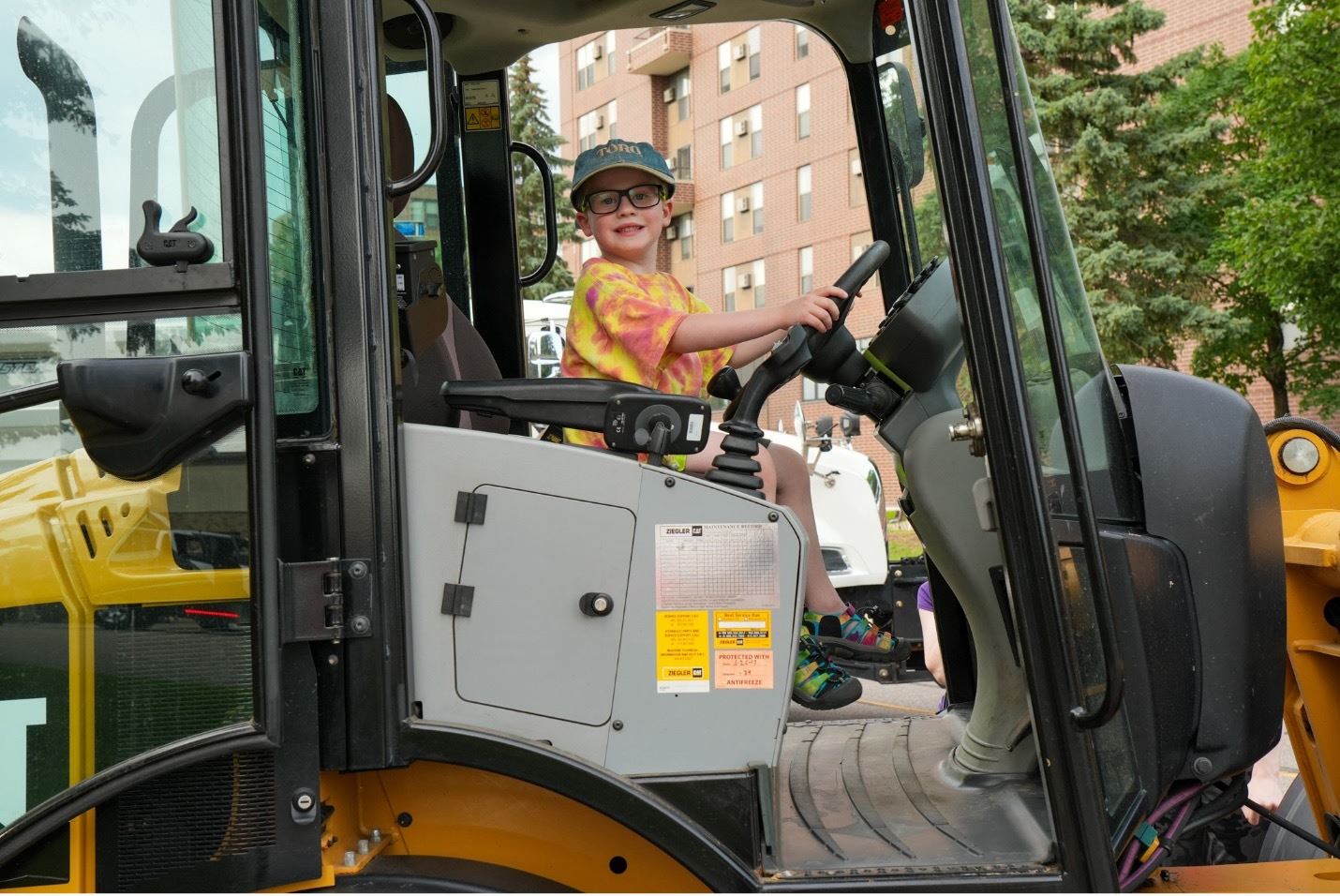 Young child pretending to ride in a truck