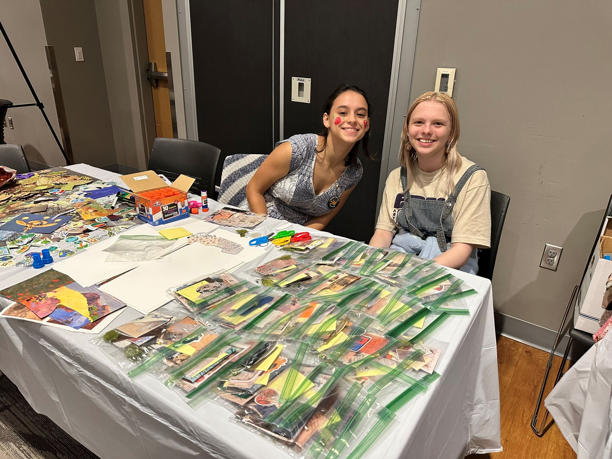 Students sit at a table during the Climate Equity Art Plan Event